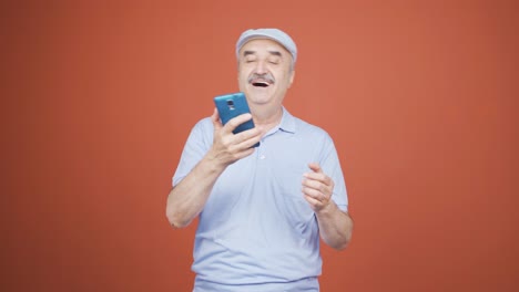 Dancing-old-man-with-phone-in-hand.